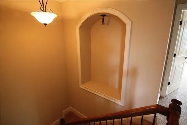 a large bed sitting in a bedroom next to a window