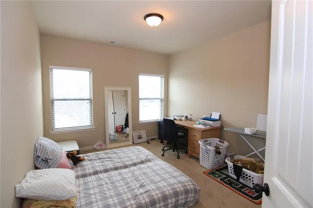 a room with a bed and mirror