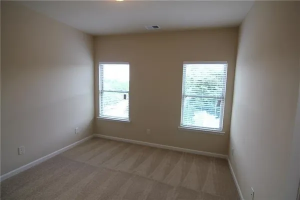 an empty room with a empty space and windows