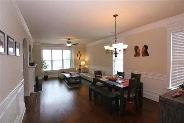 a kitchen with stainless steel appliances granite countertop a refrigerator a stove top oven a sink and dishwasher with wooden floor
