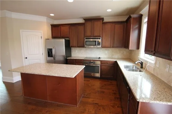 a view of empty room with wooden floor and fireplace