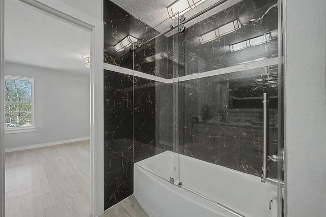 a bed sitting in a bedroom next to a window