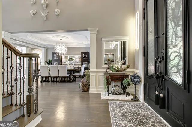 a living room with furniture a fireplace and a chandelier