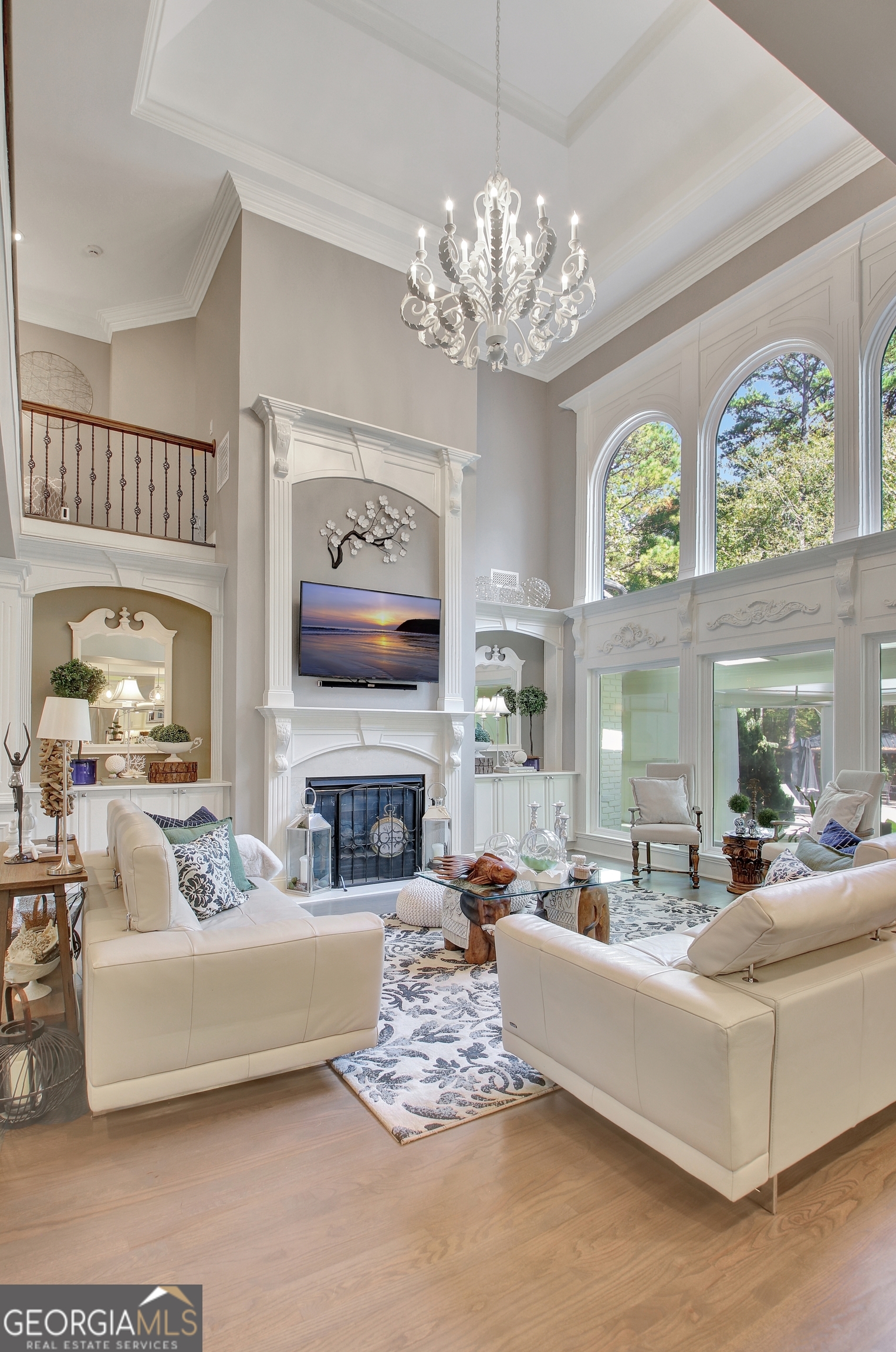 804 Ridgestone Court Peachtree City, GA 30269 - Photo 20 of 83 a living room with furniture a fireplace and a chandelier