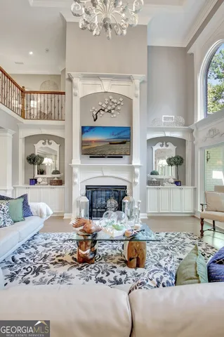 a living room with furniture fireplace and a large window