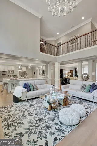 a dining room with furniture potted plants and wooden floor