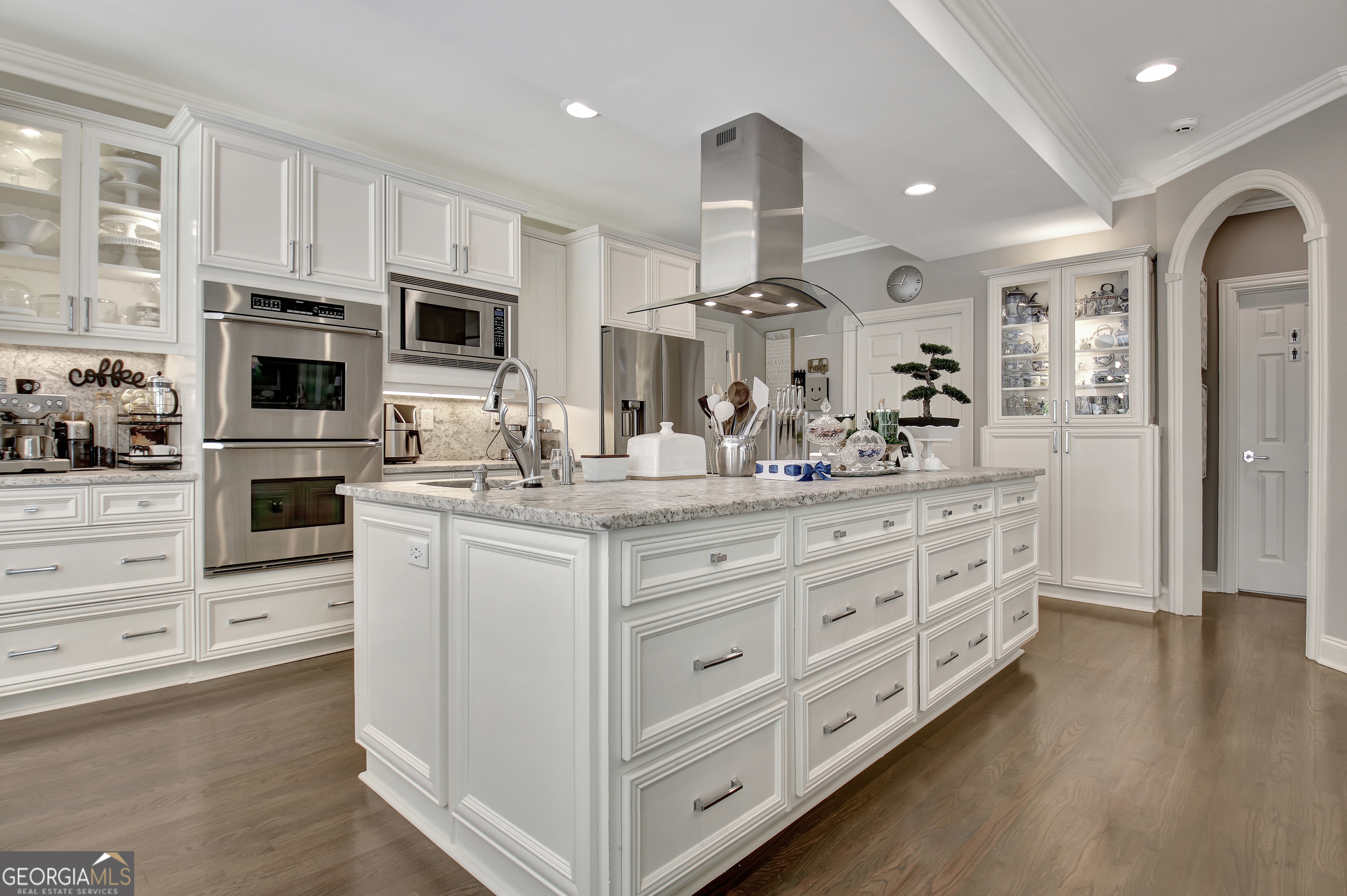 804 Ridgestone Court Peachtree City, GA 30269 - Photo 27 of 83 a kitchen with stainless steel appliances kitchen island granite countertop a stove top oven a sink a refrigerator with white cabinets and wooden floor