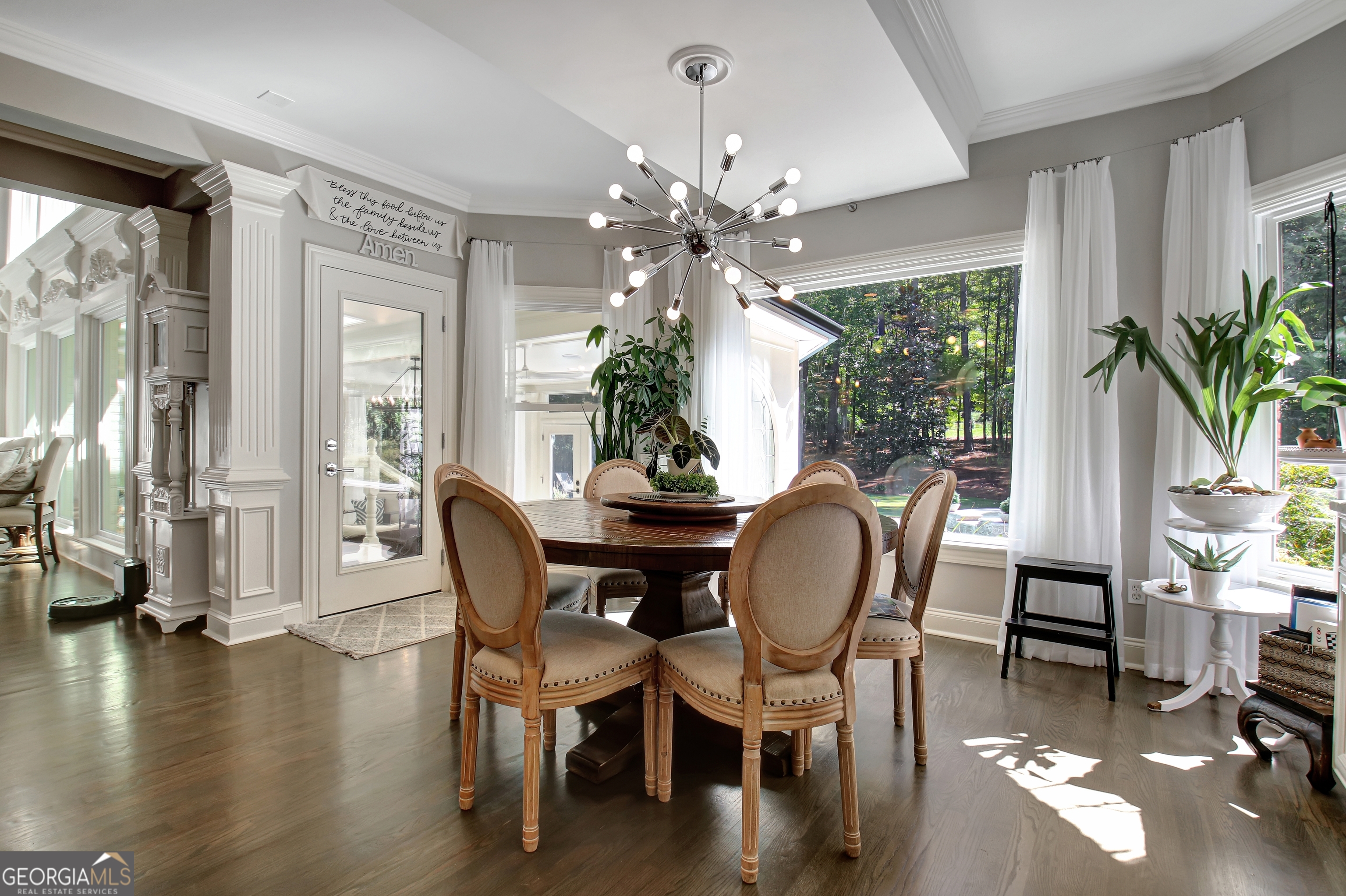 804 Ridgestone Court Peachtree City, GA 30269 - Photo 28 of 83 a dining room with furniture potted plants and wooden floor