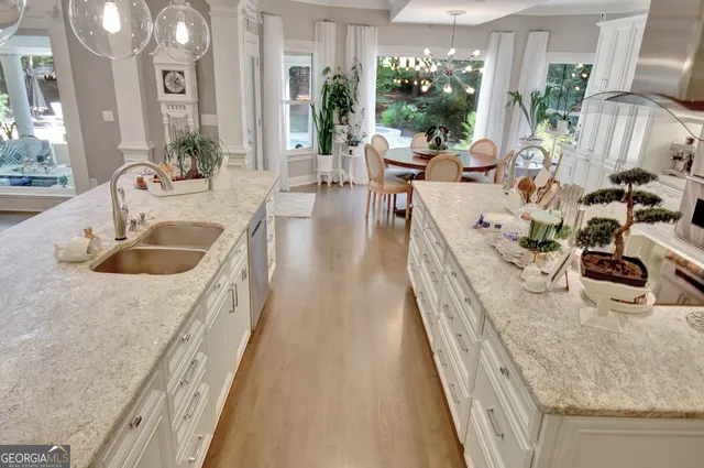 a dining room with furniture a rug and a large window