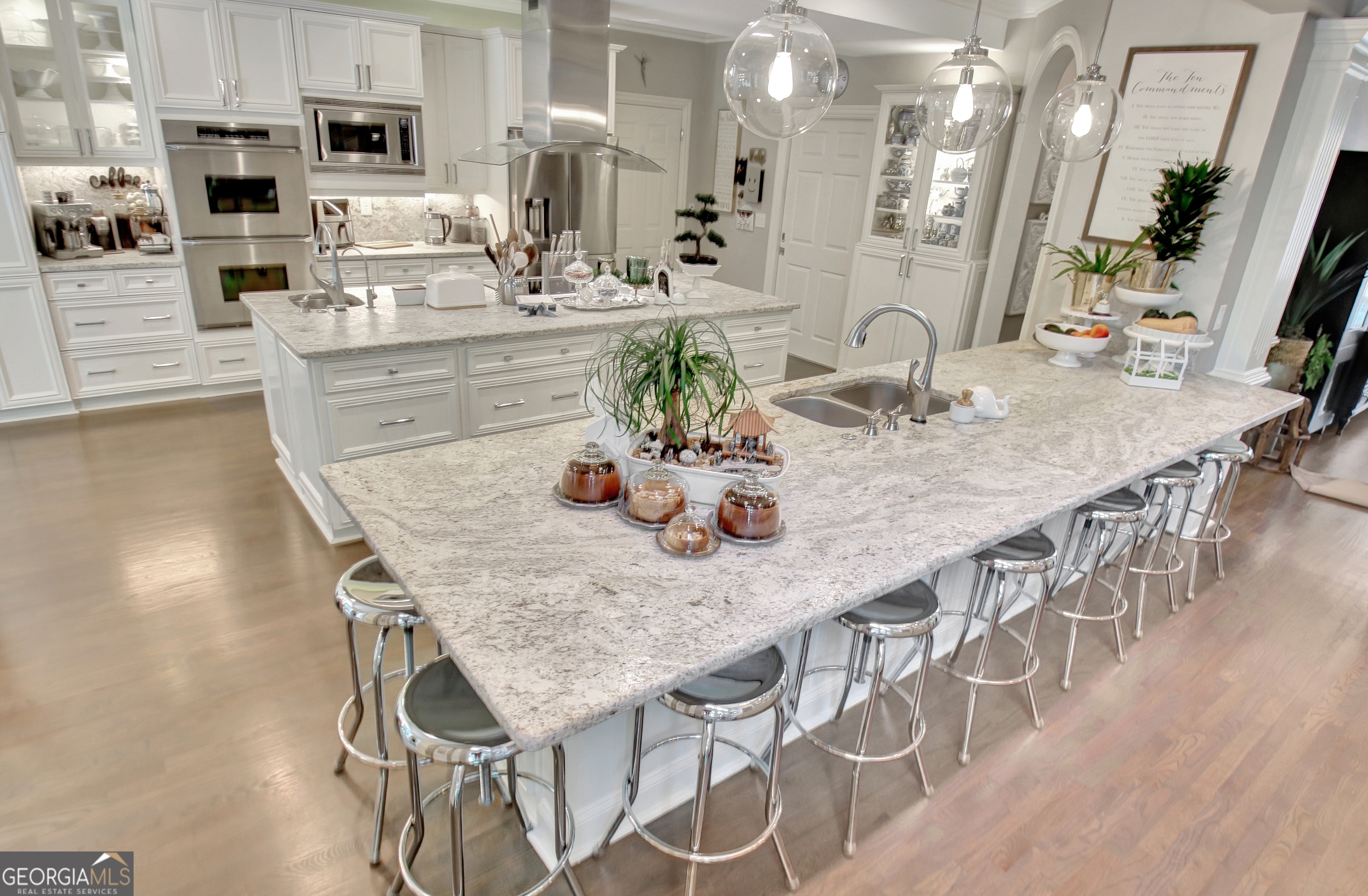 804 Ridgestone Court Peachtree City, GA 30269 - Photo 31 of 83 a kitchen with stainless steel appliances kitchen island granite countertop a table chairs sink and stove