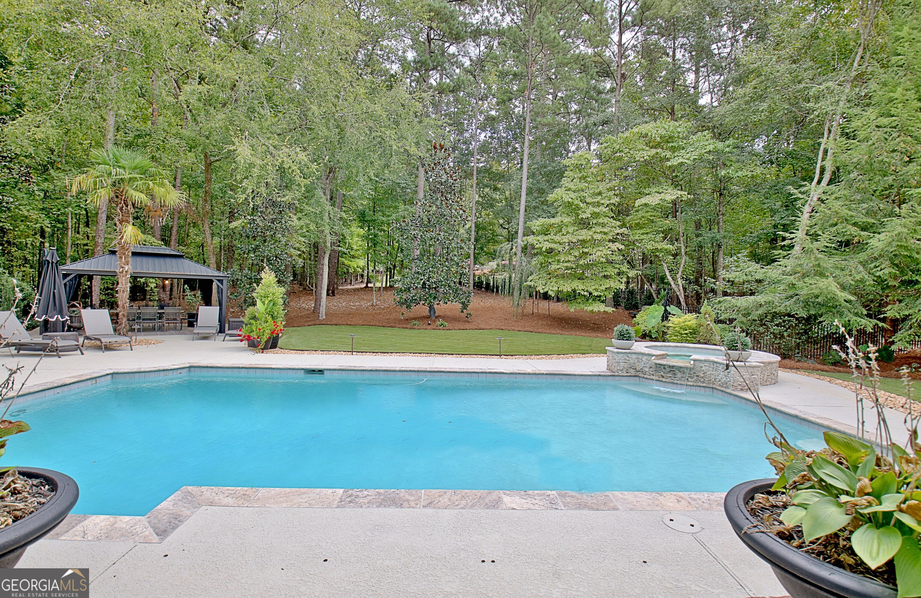 804 Ridgestone Court Peachtree City, GA 30269 - Photo 48 of 83 a view of a swimming pool with lawn chairs and plants