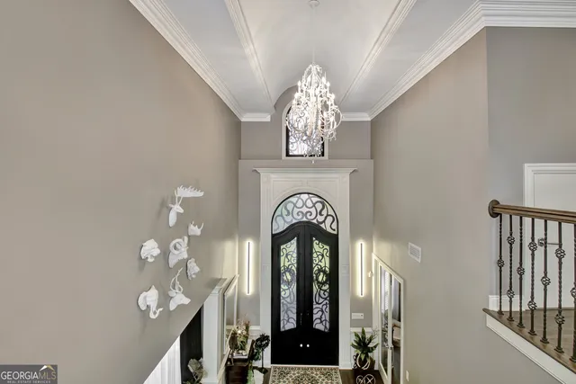 a view of a patio with table and chairs under an umbrella with a small yard