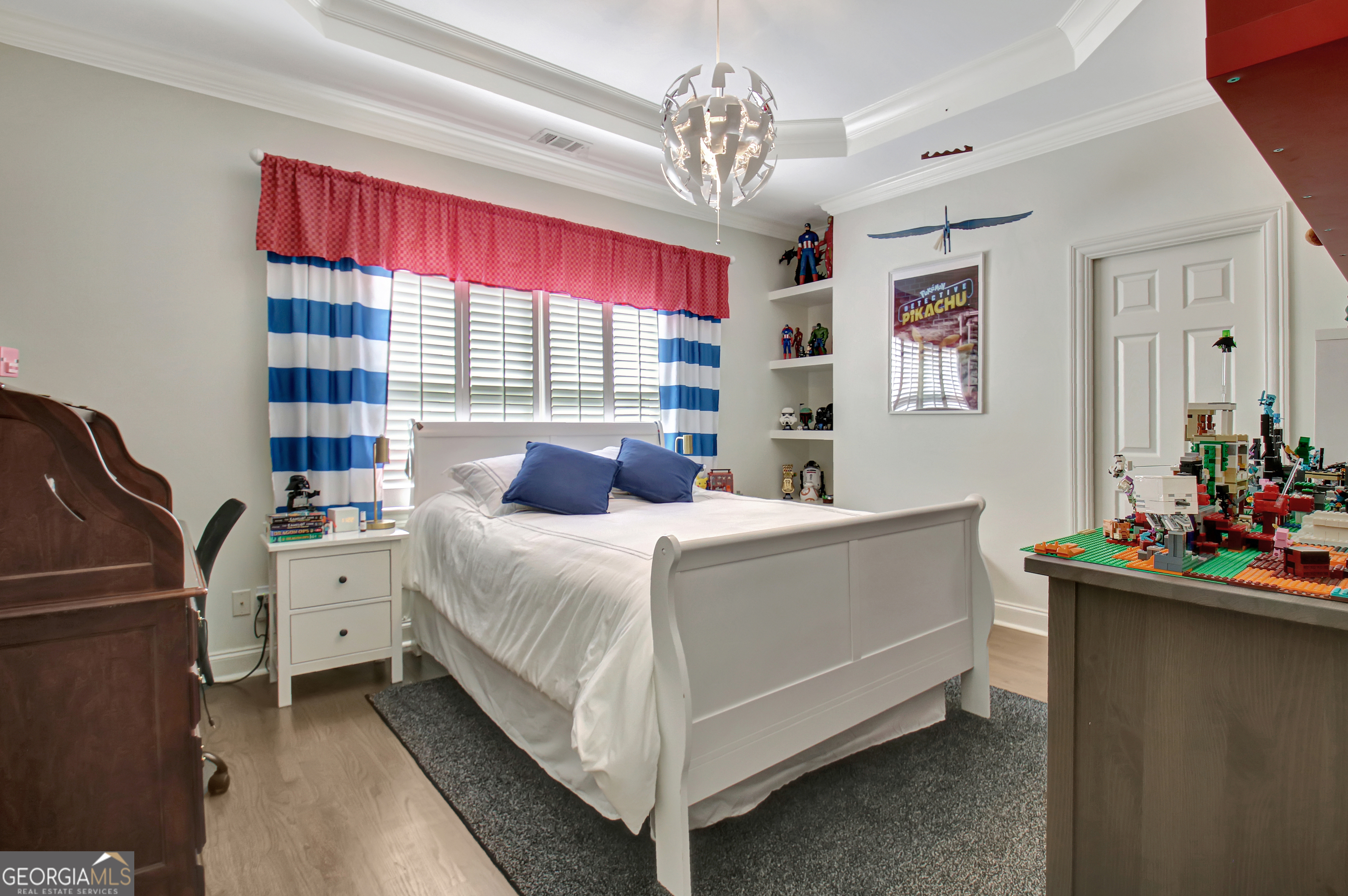 804 Ridgestone Court Peachtree City, GA 30269 - Photo 52 of 83 a bedroom with a bed and a chandelier