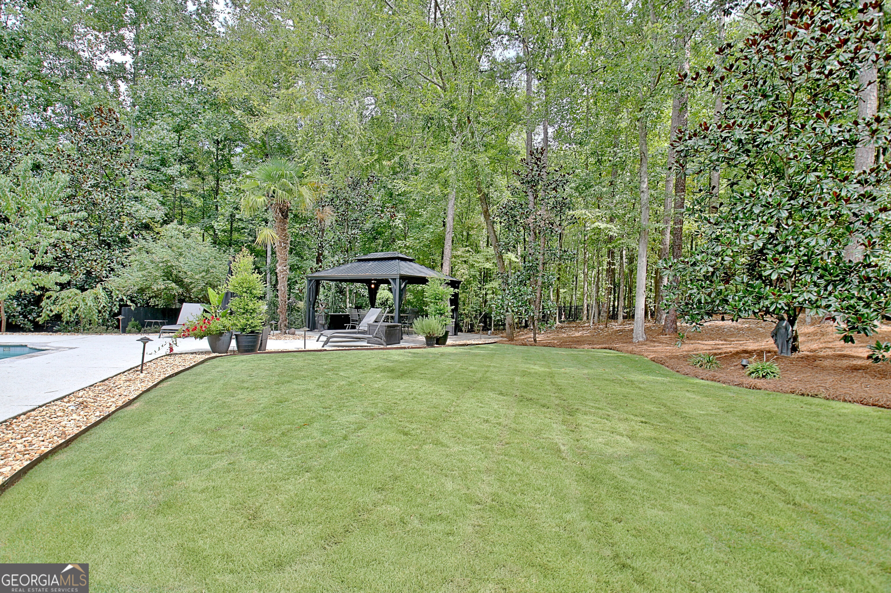 804 Ridgestone Court Peachtree City, GA 30269 - Photo 78 of 83 a view of a swimming pool and trees in the background