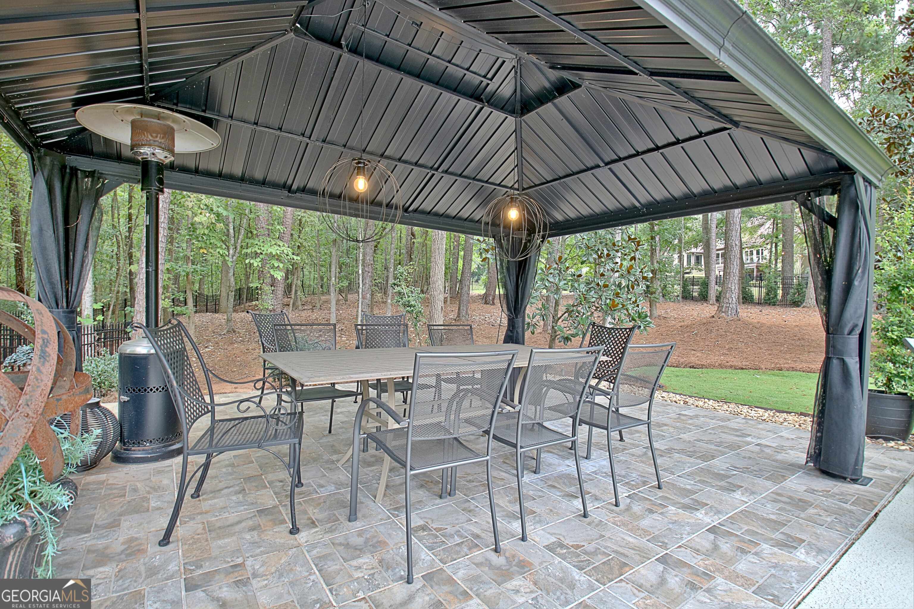 804 Ridgestone Court Peachtree City, GA 30269 - Photo 82 of 83 a view of a patio with table and chairs under an umbrella with a small yard