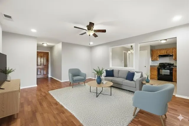 a living room with furniture and wooden floor