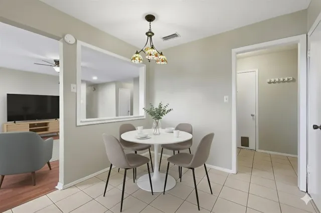a view of a dining room with furniture and a chandelier