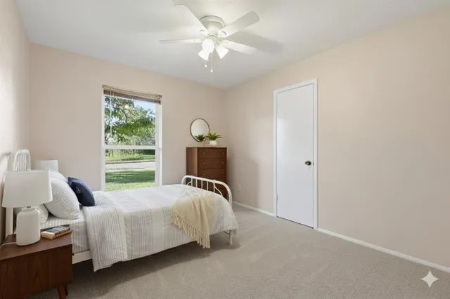 a bedroom with a bed and window