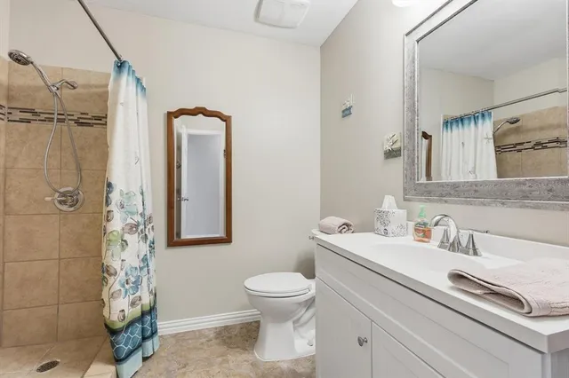 a bathroom with a toilet sink and shower