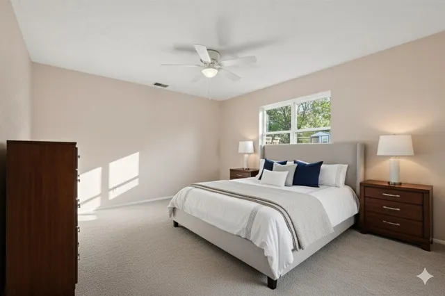 a bedroom with a bed and a lamp