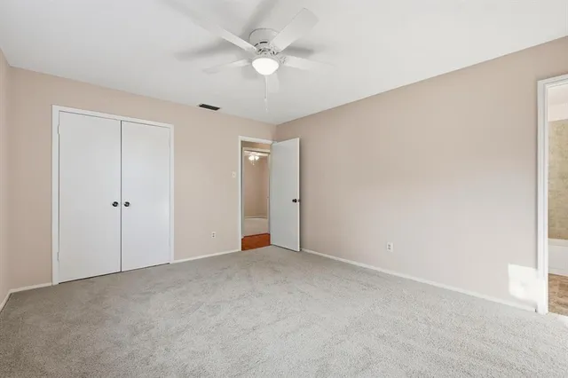 a view of an empty room with a ceiling fan