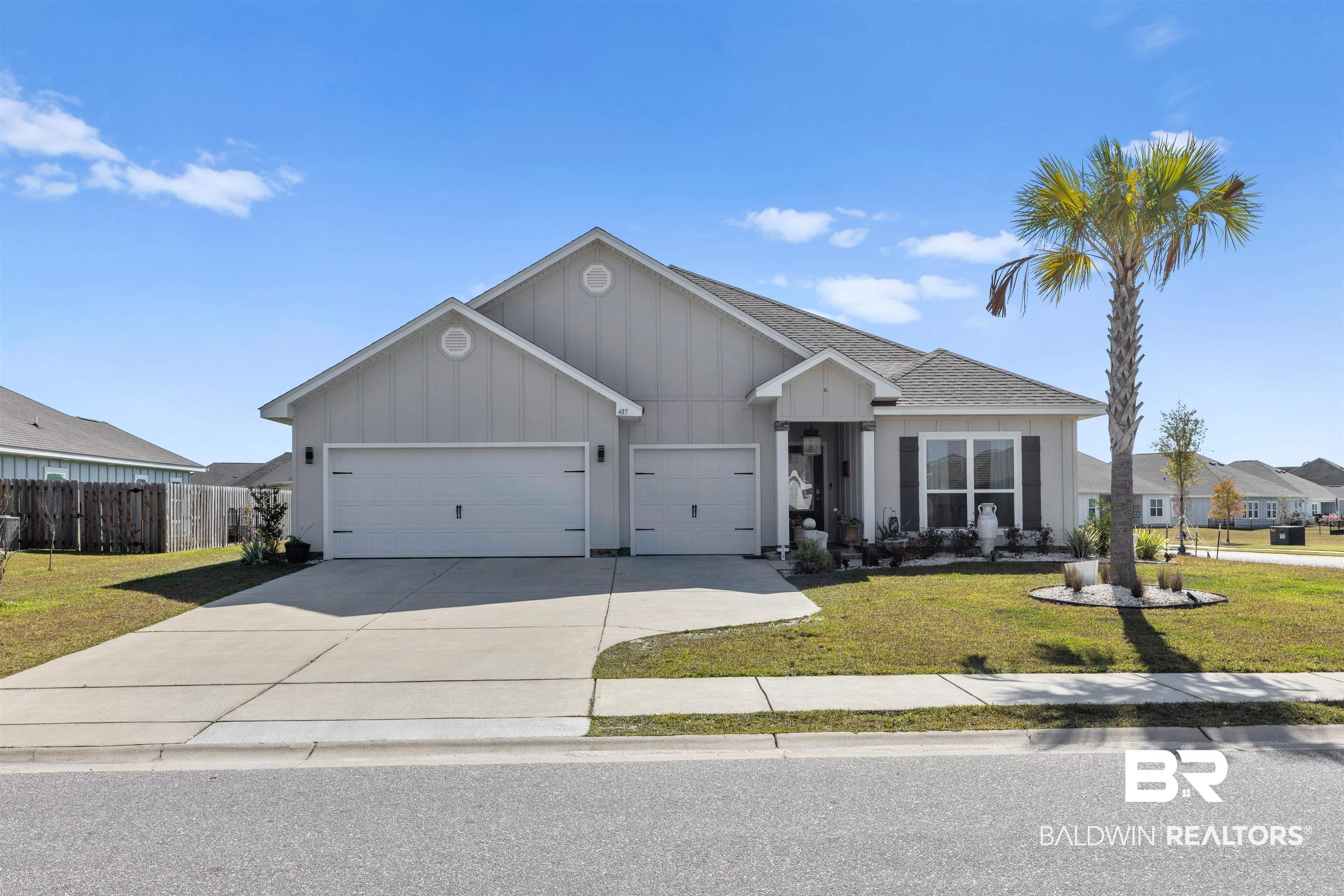 485 Shepard Street Gulf Shores, AL 36542 - Photo 1 of 53 View of front facade featuring board and batten siding, driveway, an attached garage, and roof with shingles