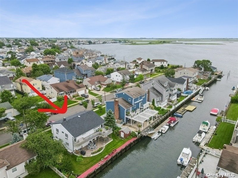 an aerial view of a house with a garden and lake view