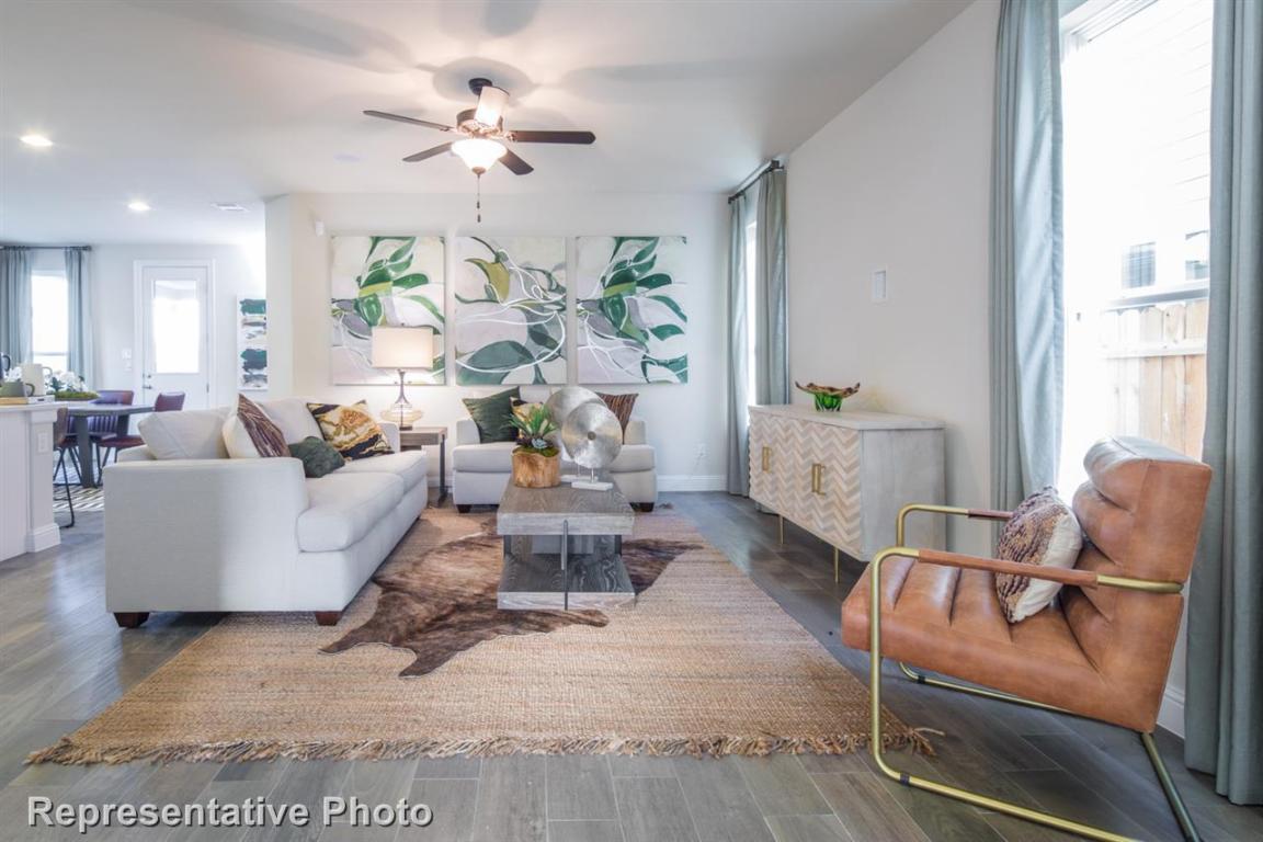164 Linnet Lane Maxwell, TX 78656 - Photo 10 of 40 a living room with furniture chandelier and a chandelier