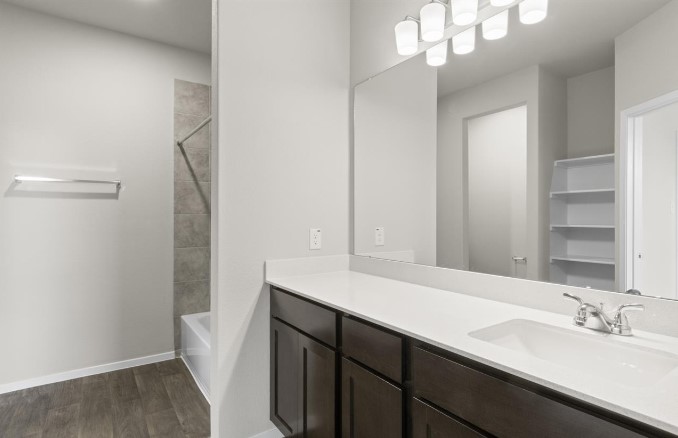 164 Linnet Lane Maxwell, TX 78656 - Photo 19 of 40 a bathroom with a sink a mirror and a shower