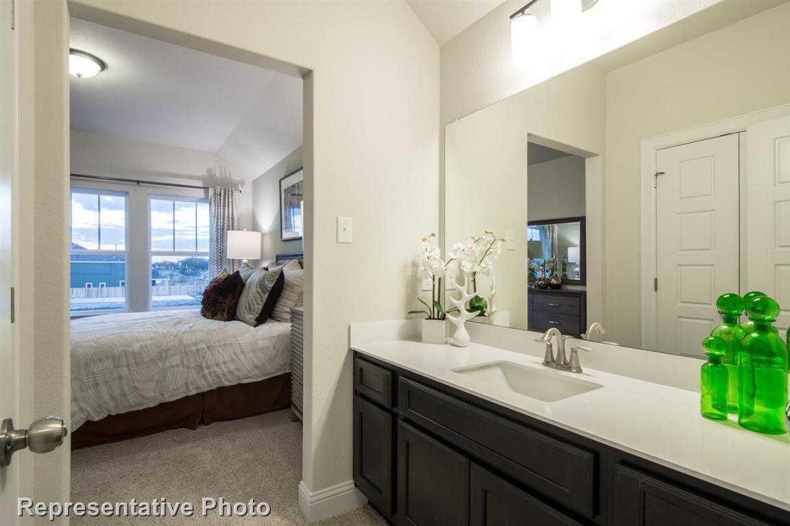 164 Linnet Lane Maxwell, TX 78656 - Photo 23 of 40 a bedroom with a bed and a potted plant