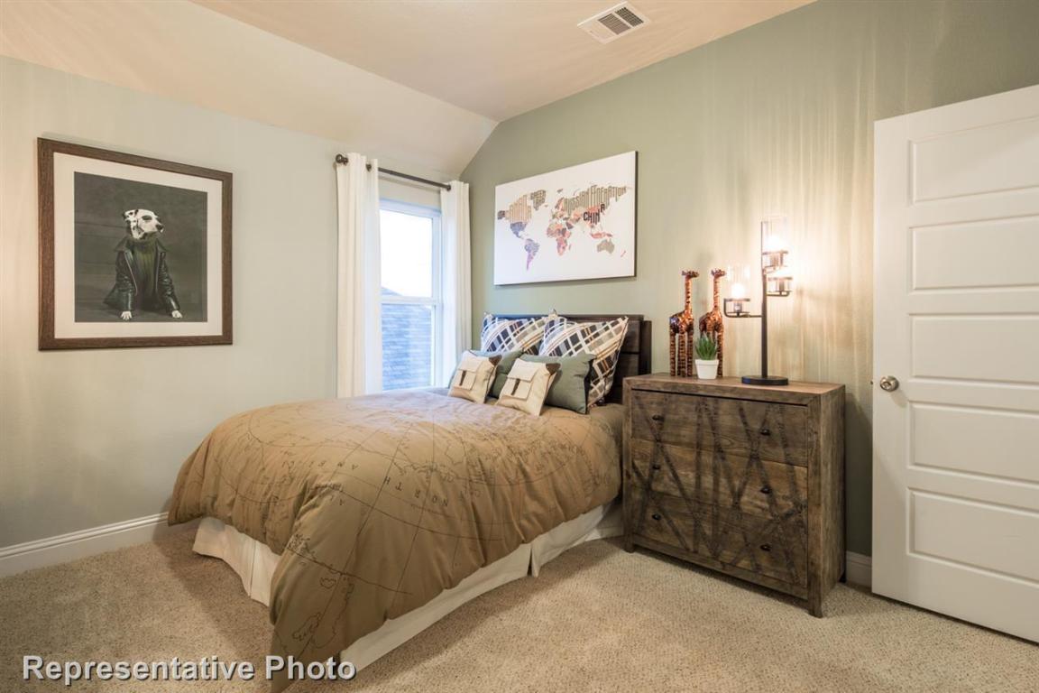 164 Linnet Lane Maxwell, TX 78656 - Photo 35 of 40 a bedroom with a bed and a painting on the wall