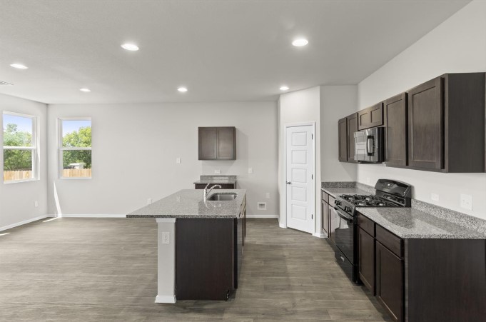 164 Linnet Lane Maxwell, TX 78656 - Photo 5 of 40 a kitchen with stainless steel appliances a stove sink microwave and refrigerator