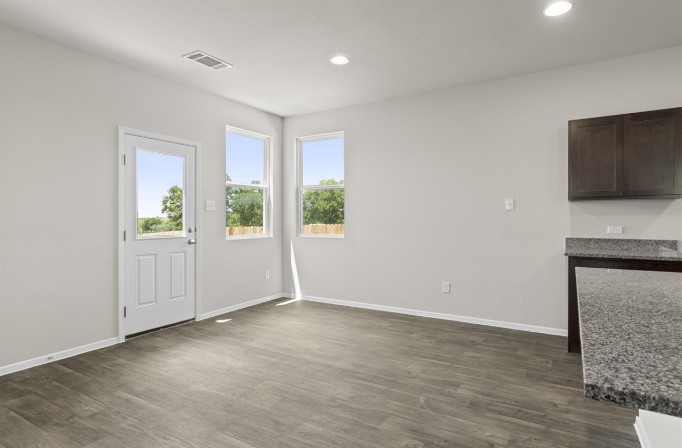 164 Linnet Lane Maxwell, TX 78656 - Photo 6 of 40 a view of an empty room with a window and wooden floor