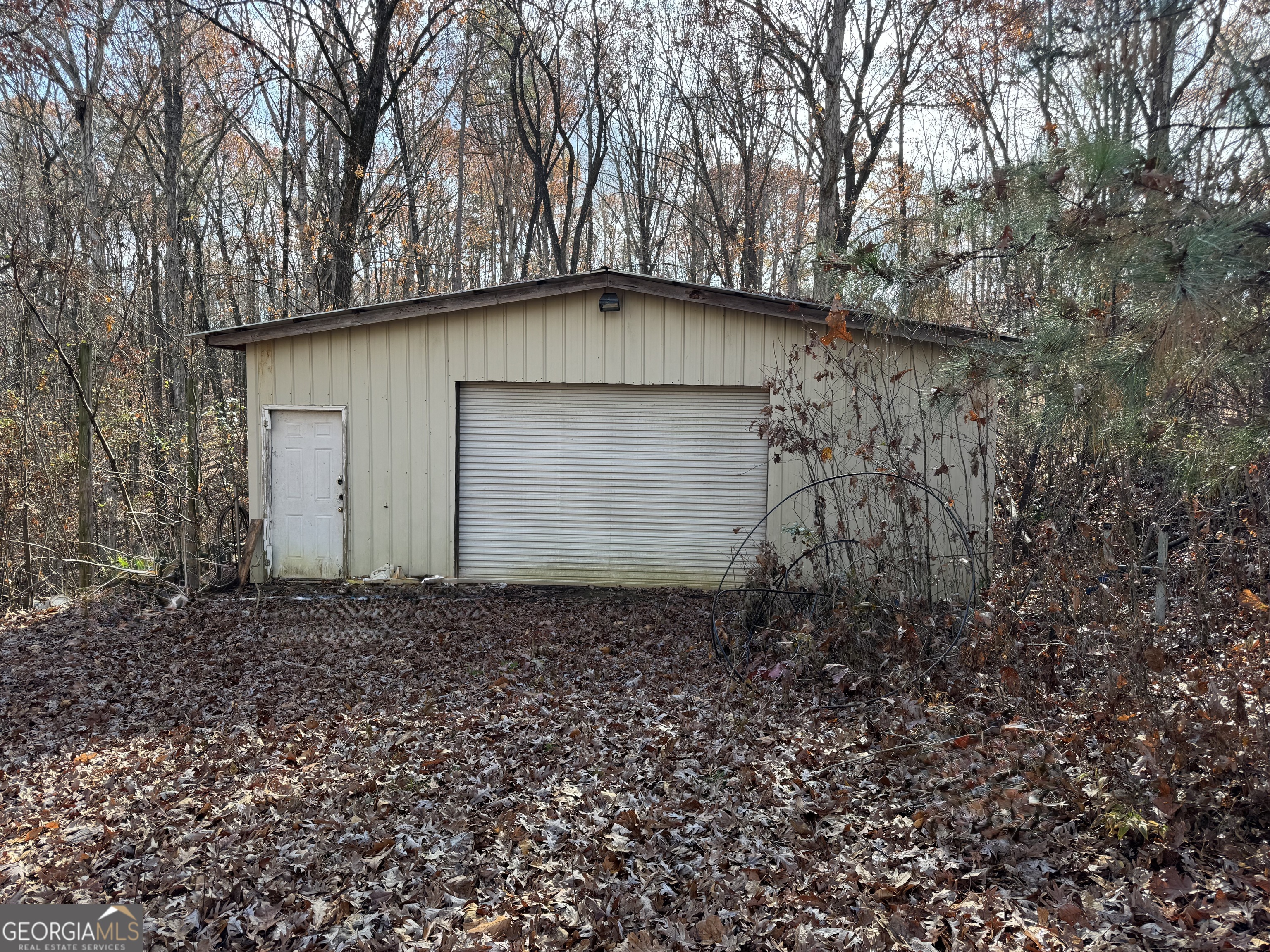 857 Laurel Lane Winder, GA 30680 - Photo 3 of 4 a backyard of a house with lots of plants and trees