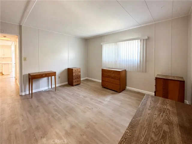 a view of room with furniture and wooden floor