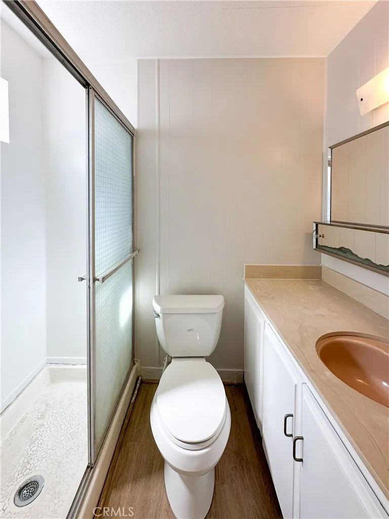 80 Huntington Street, Unit 707 Huntington Beach, CA 92648 - Photo 15 of 16 a bathroom with a toilet sink and mirror