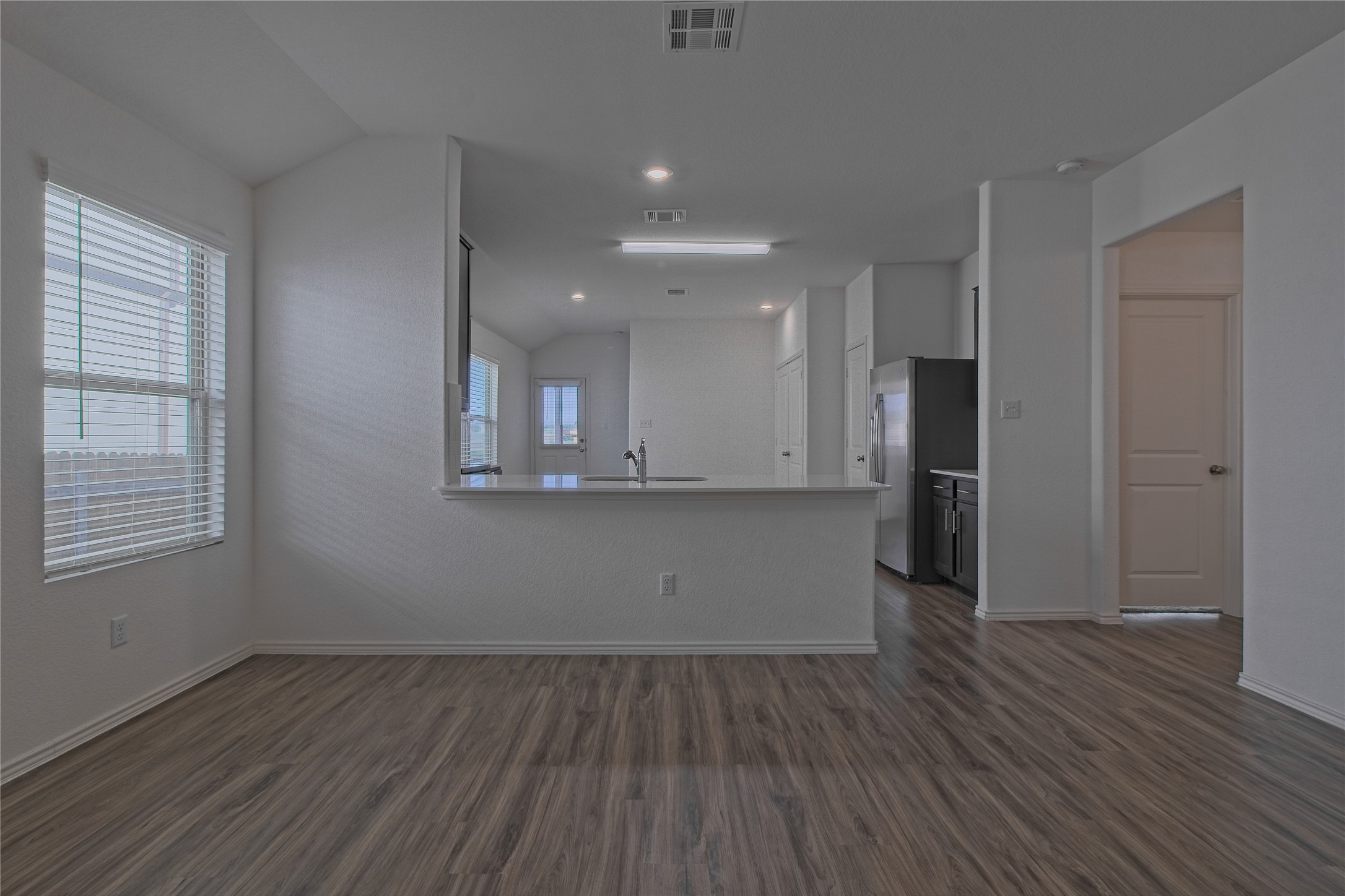505 Greatest Gift Way Jarrell, TX 76537 - Photo 11 of 30 Unfurnished room featuring vaulted ceiling, dark wood-type flooring, and recessed lighting