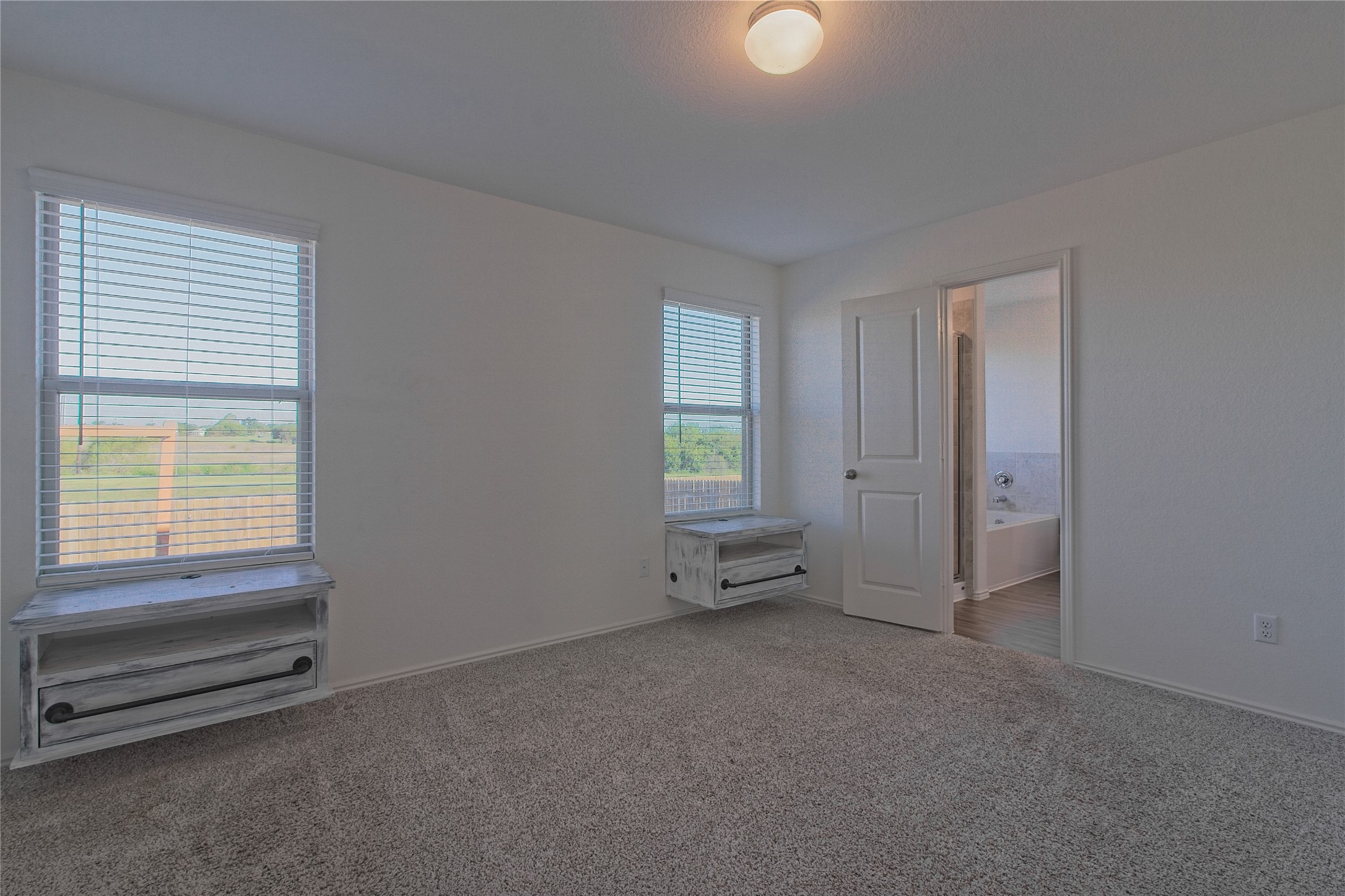 505 Greatest Gift Way Jarrell, TX 76537 - Photo 16 of 30 Unfurnished bedroom featuring carpet floors and connected bathroom
