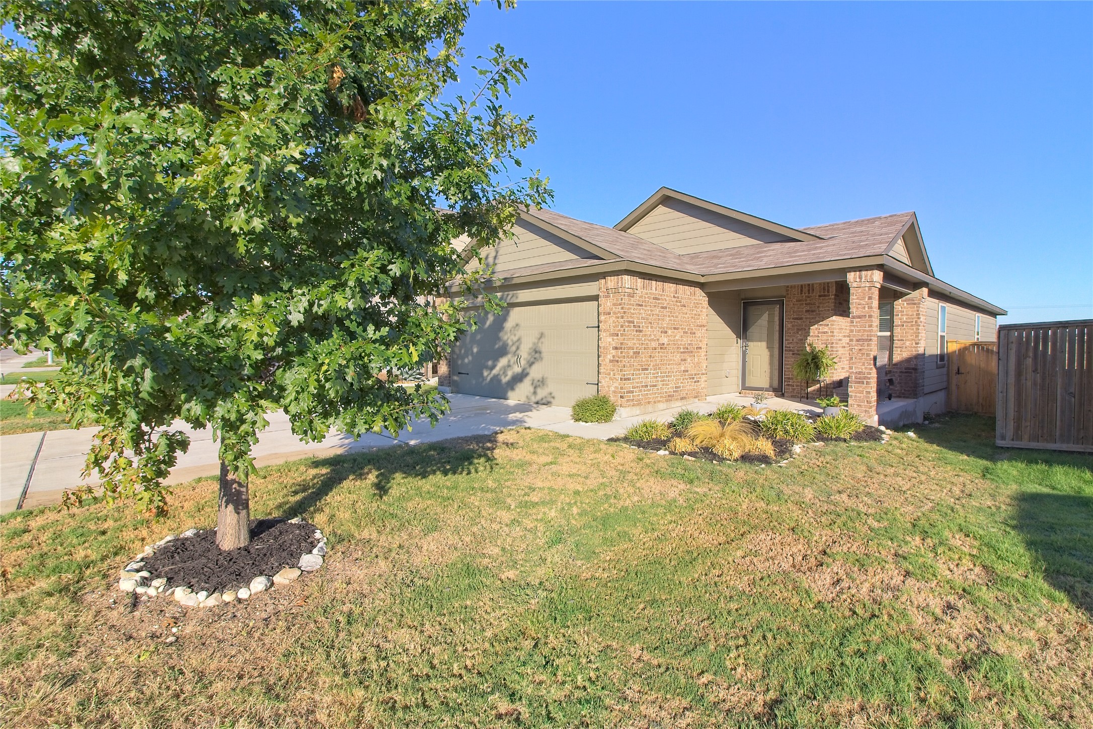 505 Greatest Gift Way Jarrell, TX 76537 - Photo 2 of 30 View of front of home with brick siding, an attached garage, and concrete driveway