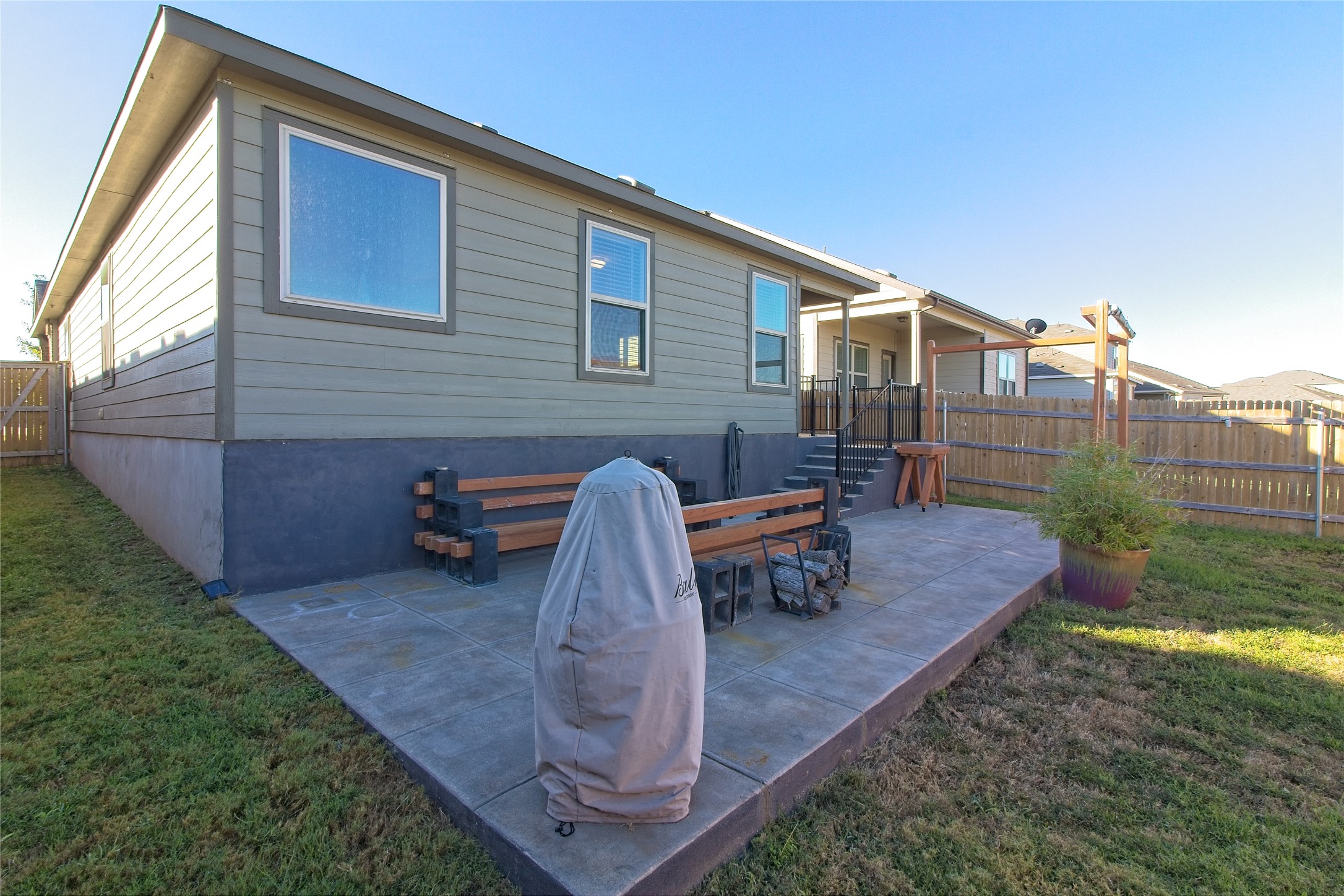 505 Greatest Gift Way Jarrell, TX 76537 - Photo 26 of 30 Back of property with a fenced backyard and a patio