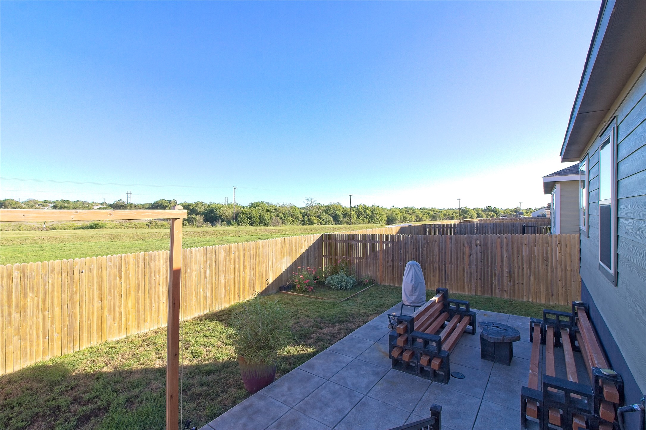 505 Greatest Gift Way Jarrell, TX 76537 - Photo 30 of 30 Fenced backyard with a patio, a fire pit, and a view of countryside