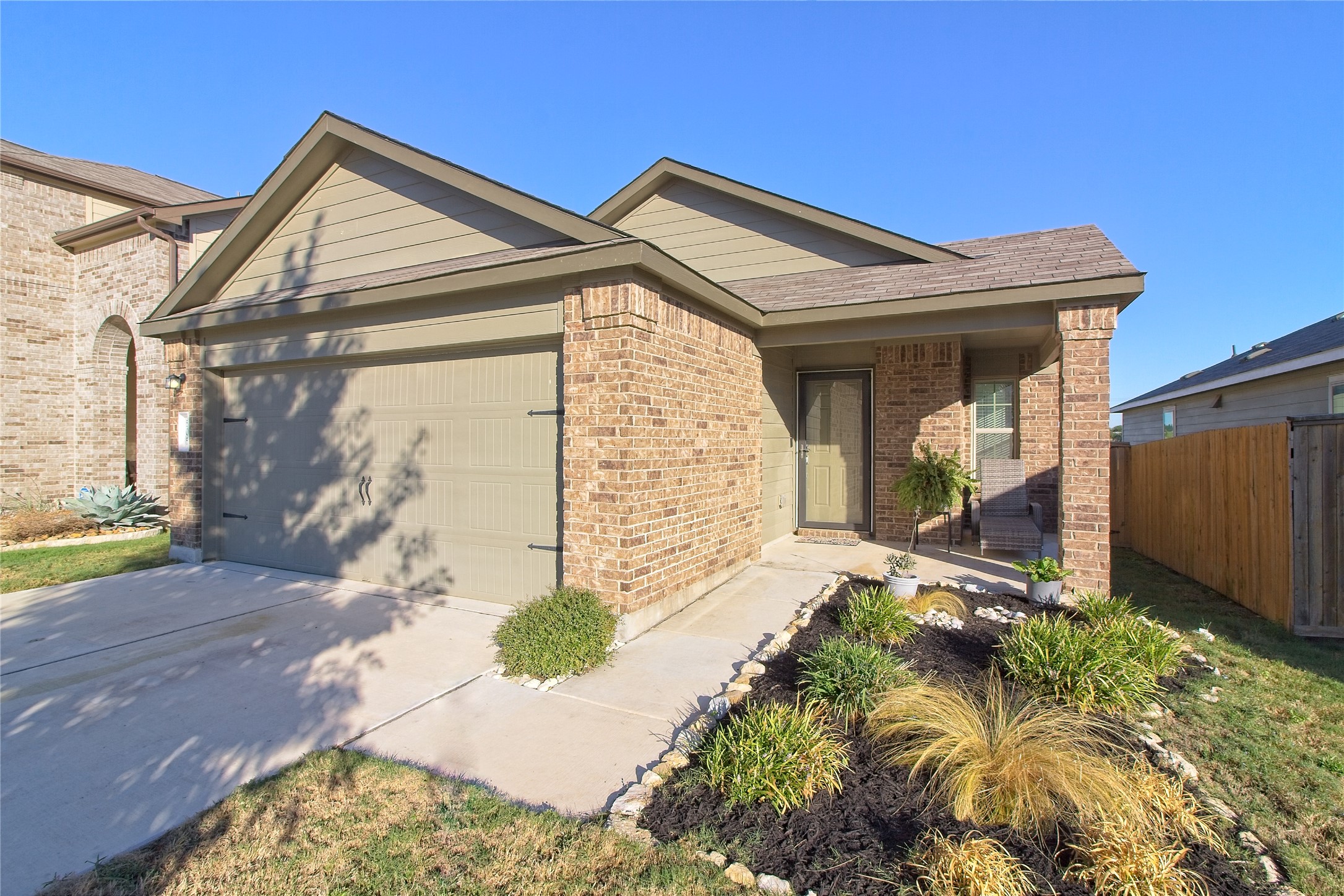 505 Greatest Gift Way Jarrell, TX 76537 - Photo 4 of 30 View of front of home with brick siding, an attached garage, and driveway