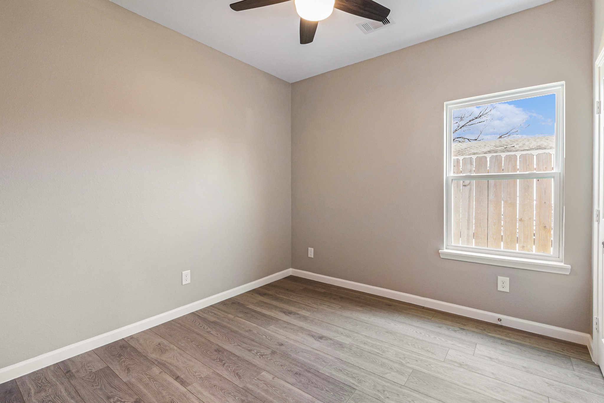 4645 Larkspur Street Houston, TX 77051 - Photo 13 of 16 an empty room with windows and fan