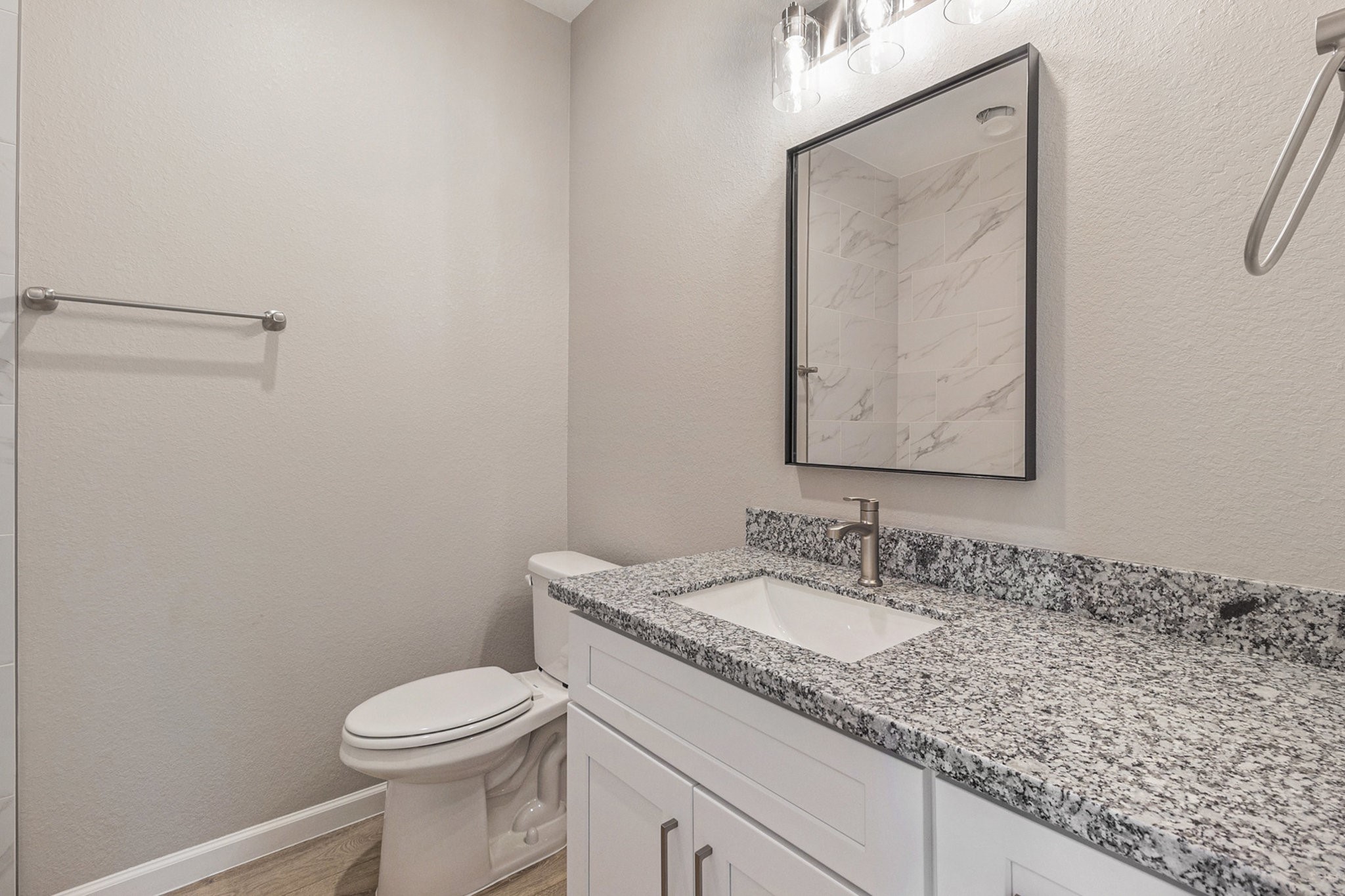 4645 Larkspur Street Houston, TX 77051 - Photo 14 of 16 a bathroom with a granite countertop sink vanity mirror and toilet