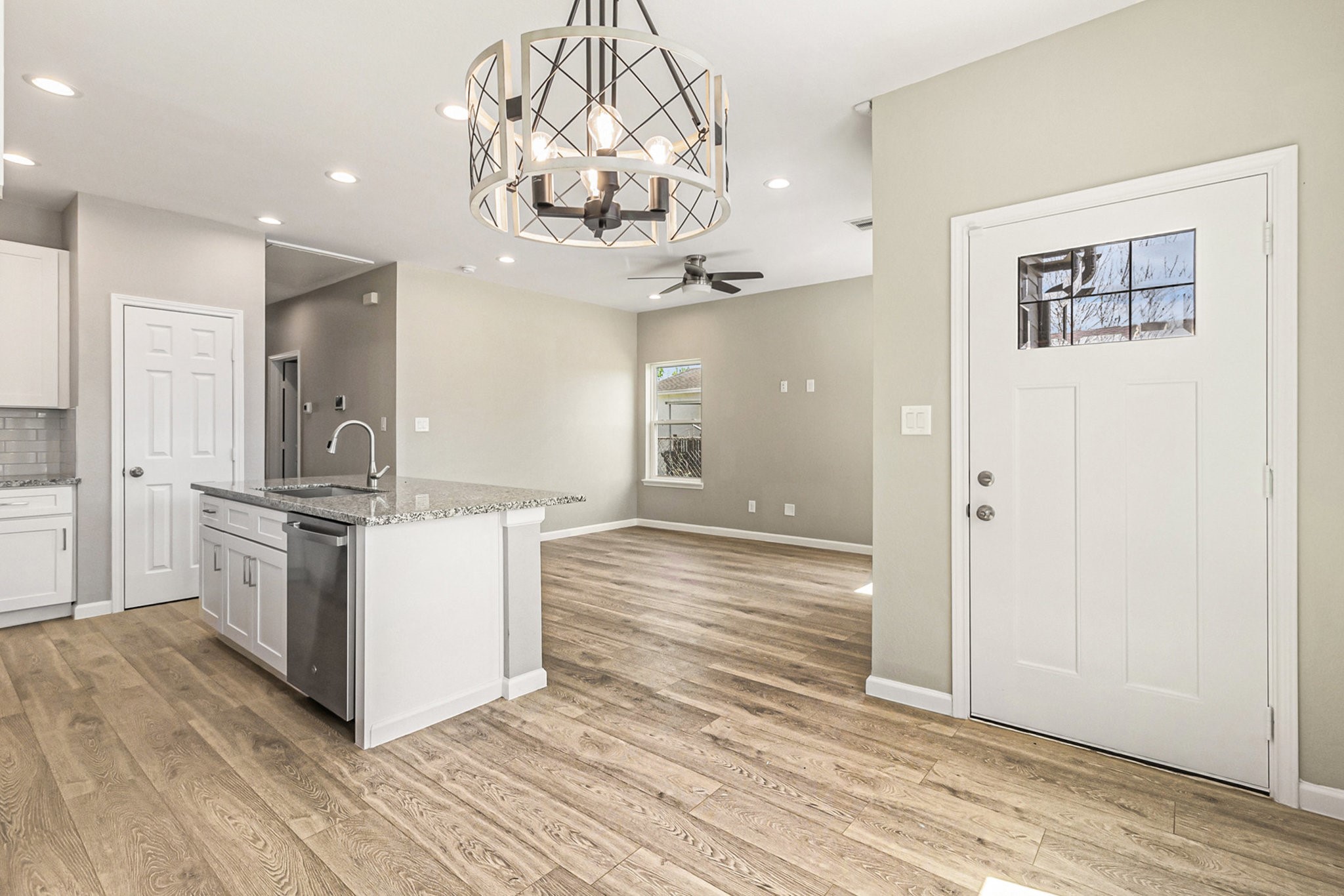 4645 Larkspur Street Houston, TX 77051 - Photo 3 of 16 a kitchen with stainless steel appliances granite countertop a white stove top oven and chandelier