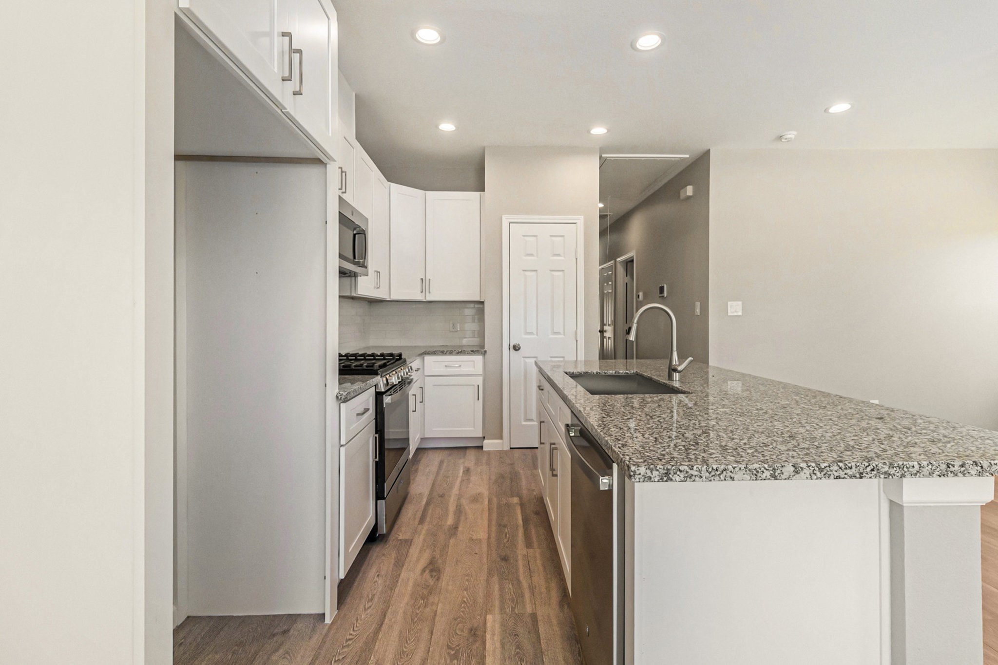 4645 Larkspur Street Houston, TX 77051 - Photo 8 of 16 a kitchen with stainless steel appliances granite countertop a sink stove and refrigerator