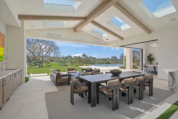 a view of a big dining room with furniture window and outside view