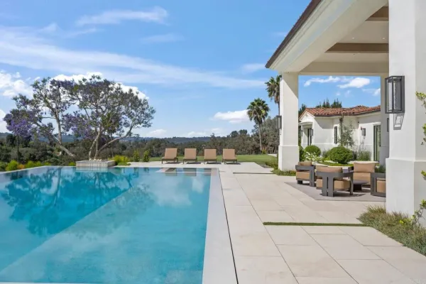 a view of swimming pool with outdoor seating and plants