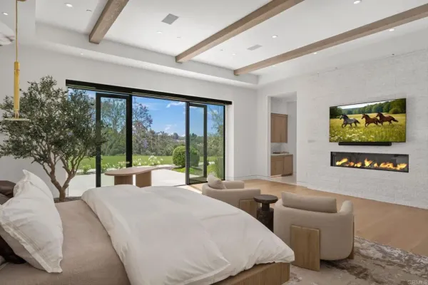 a bedroom with furniture and large windows