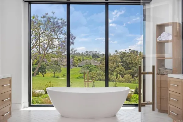 a white bath tub sitting in front of a window